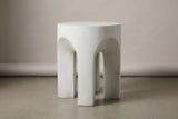 The Aragona antique white arched side table, three-quarter view on a light studio backdrop