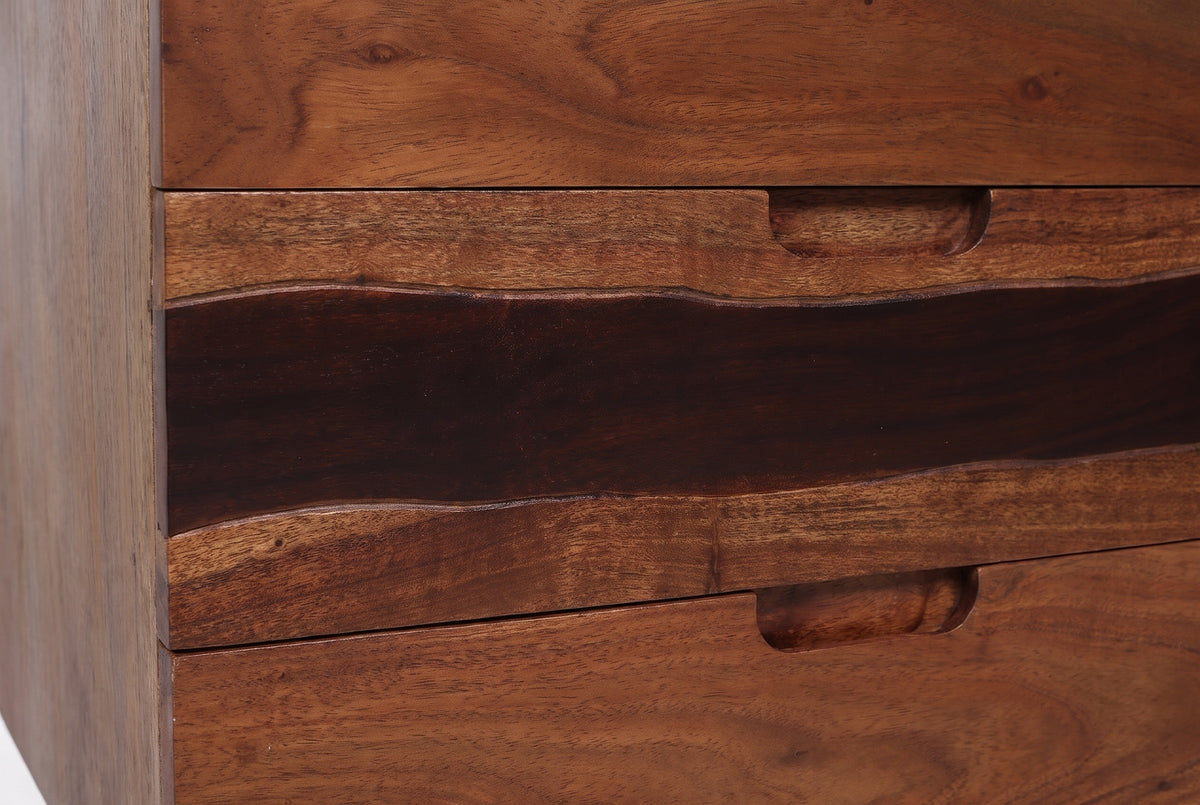 The middle drawer of the Arborea nightstand: a dark band with wavy edges between lighter walnut-brown acacia, and the carved finger slot in its top edge