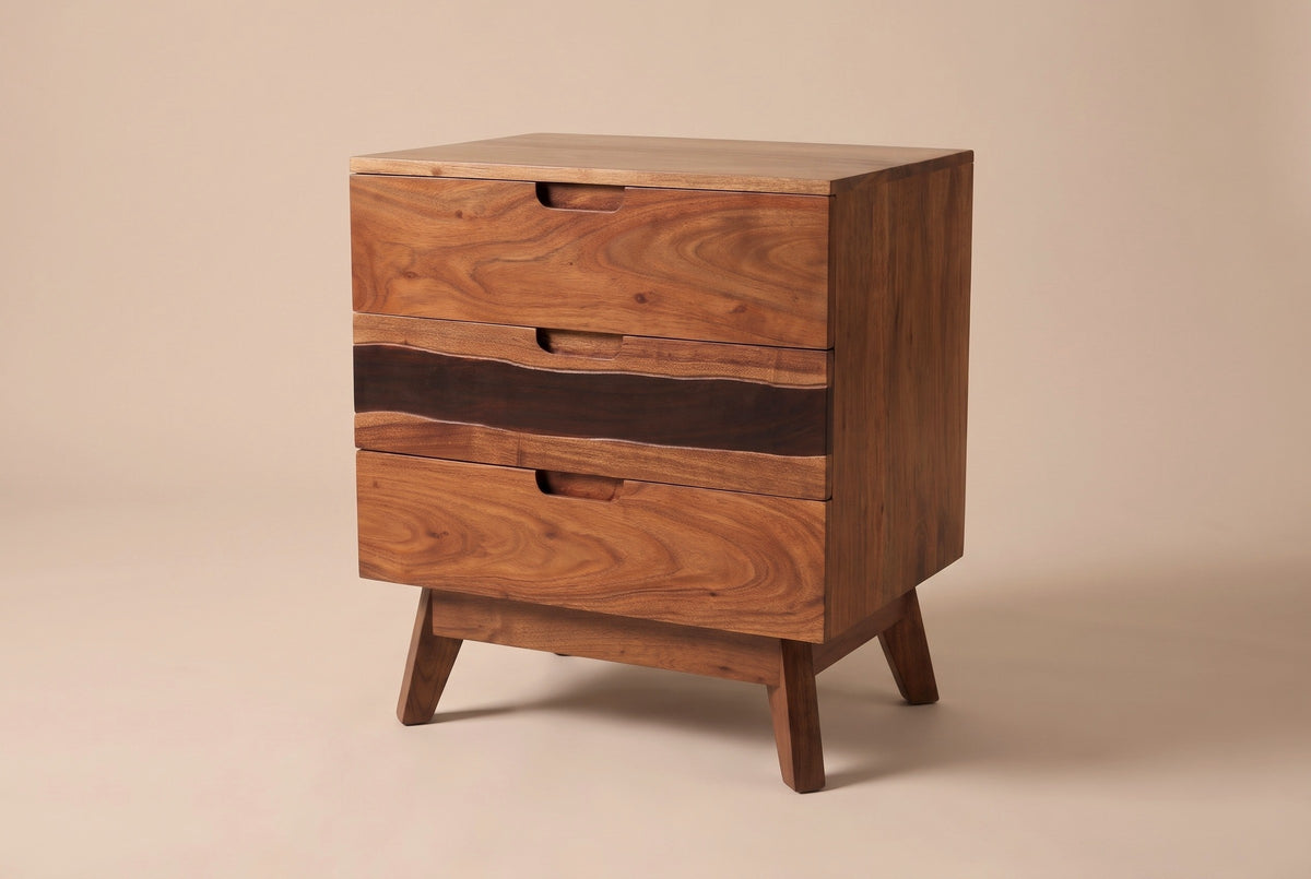 The Arborea three-drawer nightstand in walnut-brown acacia with a dark band across the middle drawer, three-quarter view on a light studio backdrop