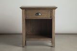 The Arbus nightstand in rustic aged brown, front view on a light studio backdrop