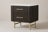 The Aritzo two-drawer nightstand in espresso with wide vertical reeds, a white engineered-stone top, gold bar pulls and gold legs, three-quarter view on a light studio backdrop