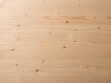 Close-up of the Arona 31.5-Inch Round Solid Fir Storage Drum Coffee Table: the natural fir grain and knots of the top