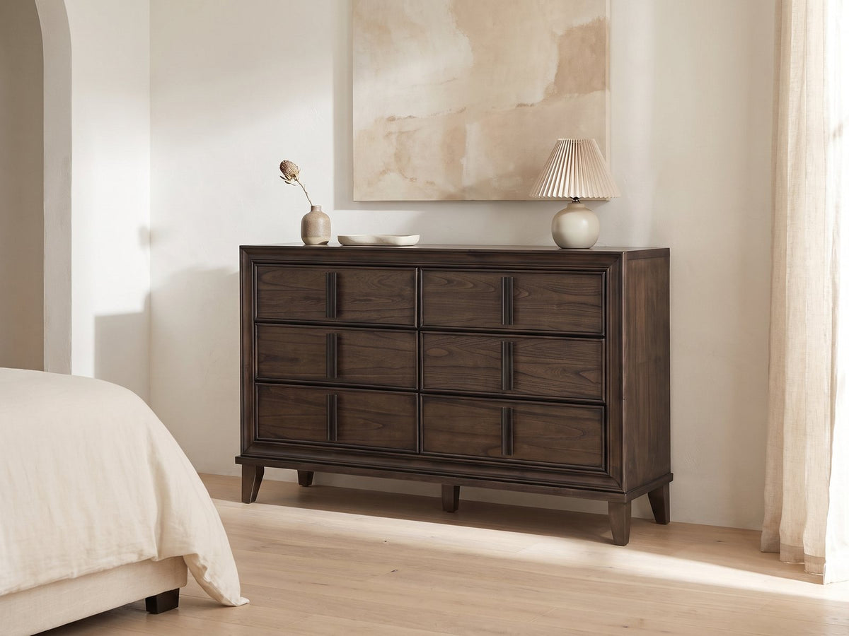 Arta 61-Inch Dark Brown 6-Drawer Dresser against a plaster wall under an abstract canvas in a bright bedroom