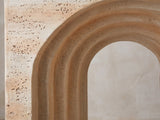 Close-up of the Asiago Faux Travertine Arched Console Table: the four stepped rings of the arch