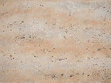 Close-up of the Asiago Faux Travertine Arched Console Table: the pitted, matte travertine-look texture of the magnesium oxide surface