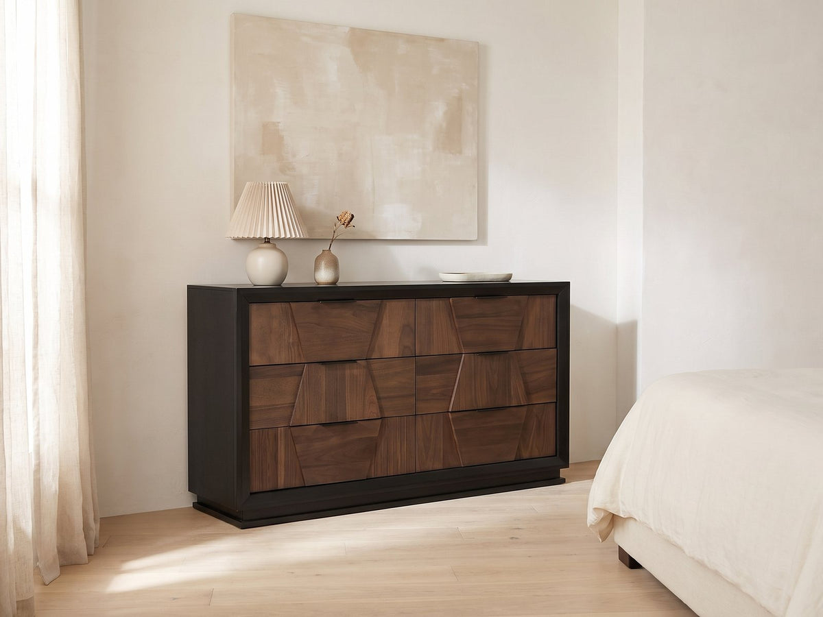 Asolo 61-Inch Walnut and Black 6-Drawer Dresser against a plaster wall under an abstract canvas in a bright bedroom