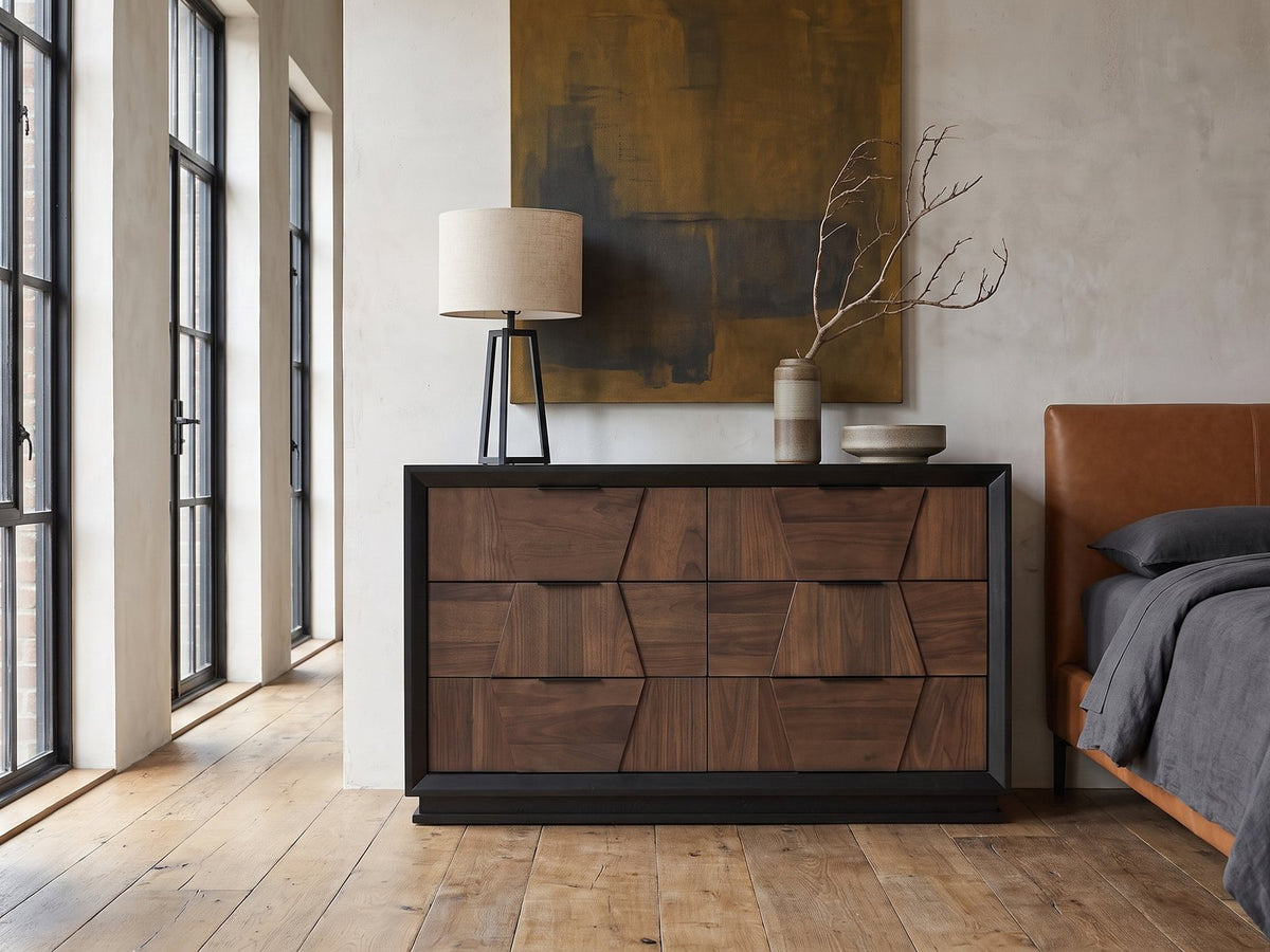 Asolo 61-Inch Walnut and Black 6-Drawer Dresser against a plaster wall in an industrial loft bedroom