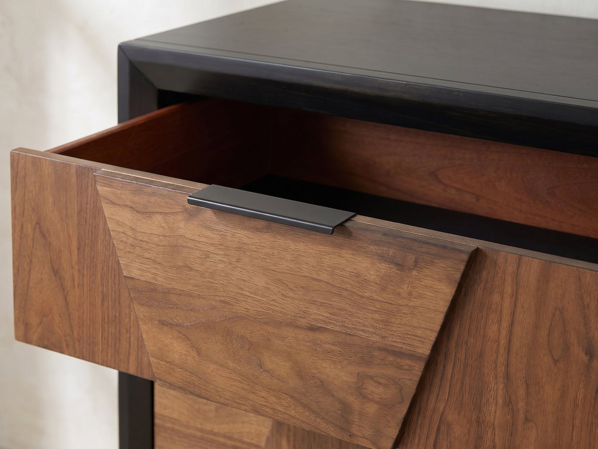 Close-up of the Asolo 61-Inch Walnut and Black 6-Drawer Dresser: the slim matte black tab pull on the top edge of a walnut drawer front