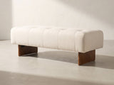 Assisi Tufted Bench in ivory against a plaster wall in morning light