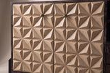 The two carved doors of the Atella sideboard up close: sand-colored square tiles rising to sharp pyramid points, with a small antique-brass pyramid knob near the top of each door