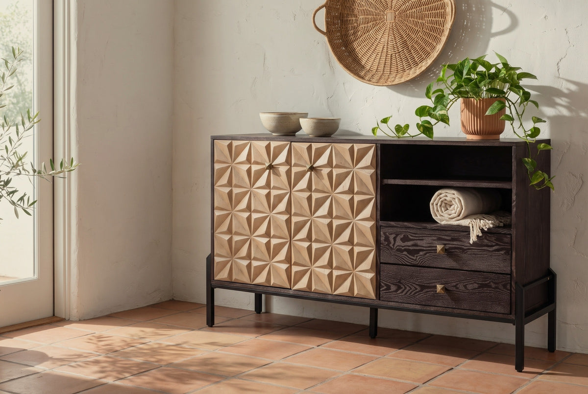 Atella carved pyramid-relief sideboard in a Santa Barbara living room with a white-washed stucco wall, terracotta tiles and a glass door at the left