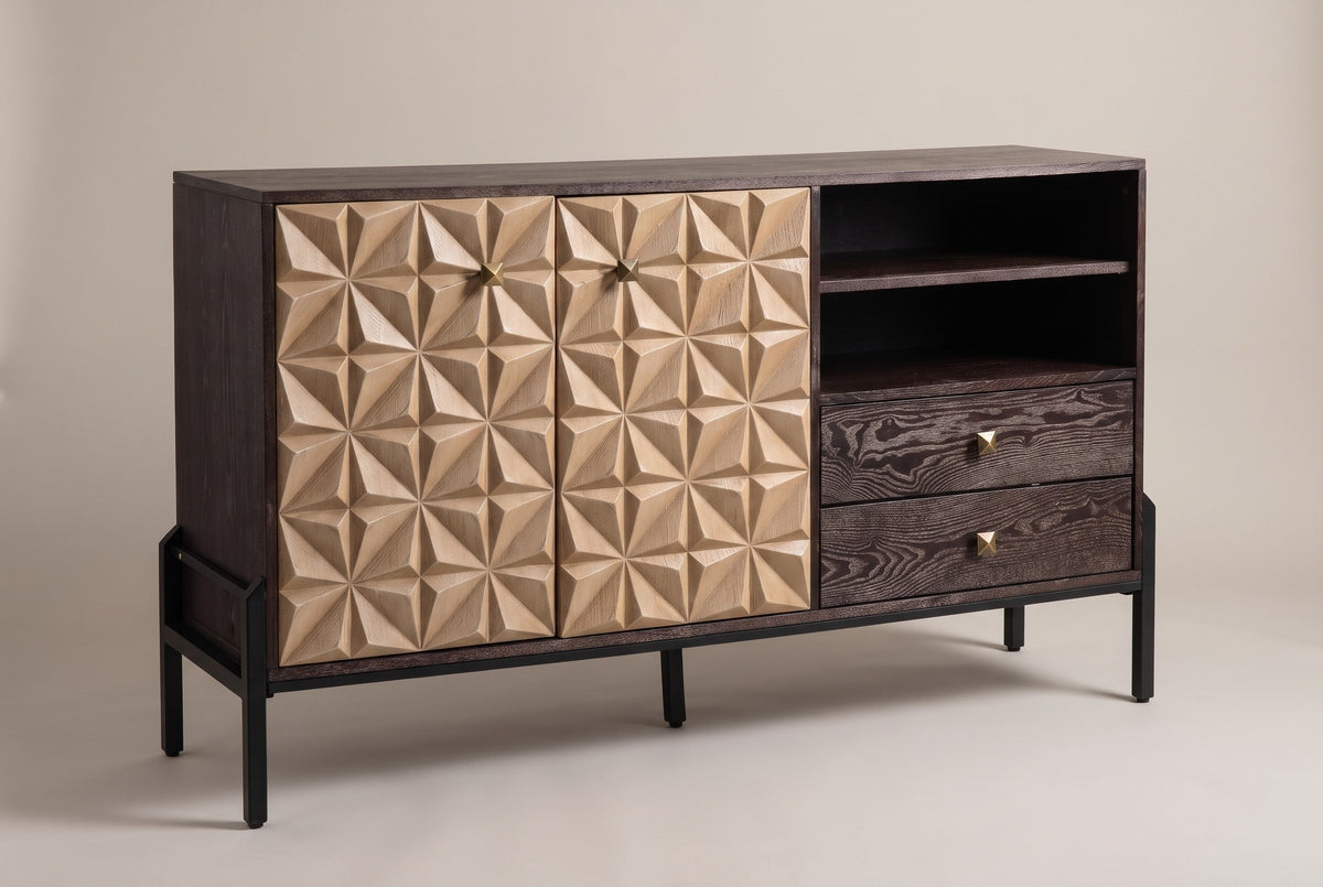 The Atella sideboard with two sand-colored carved doors, open cubbies and two espresso drawers on a black metal base, three-quarter view on a light studio backdrop