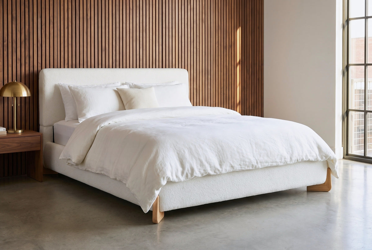 Atessa bed against a wall of vertical walnut slats in a Nashville loft with a polished concrete floor