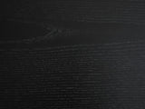 Close-up of the Atina Black Ash Oval Console Table: the open-pore black ash grain of the top