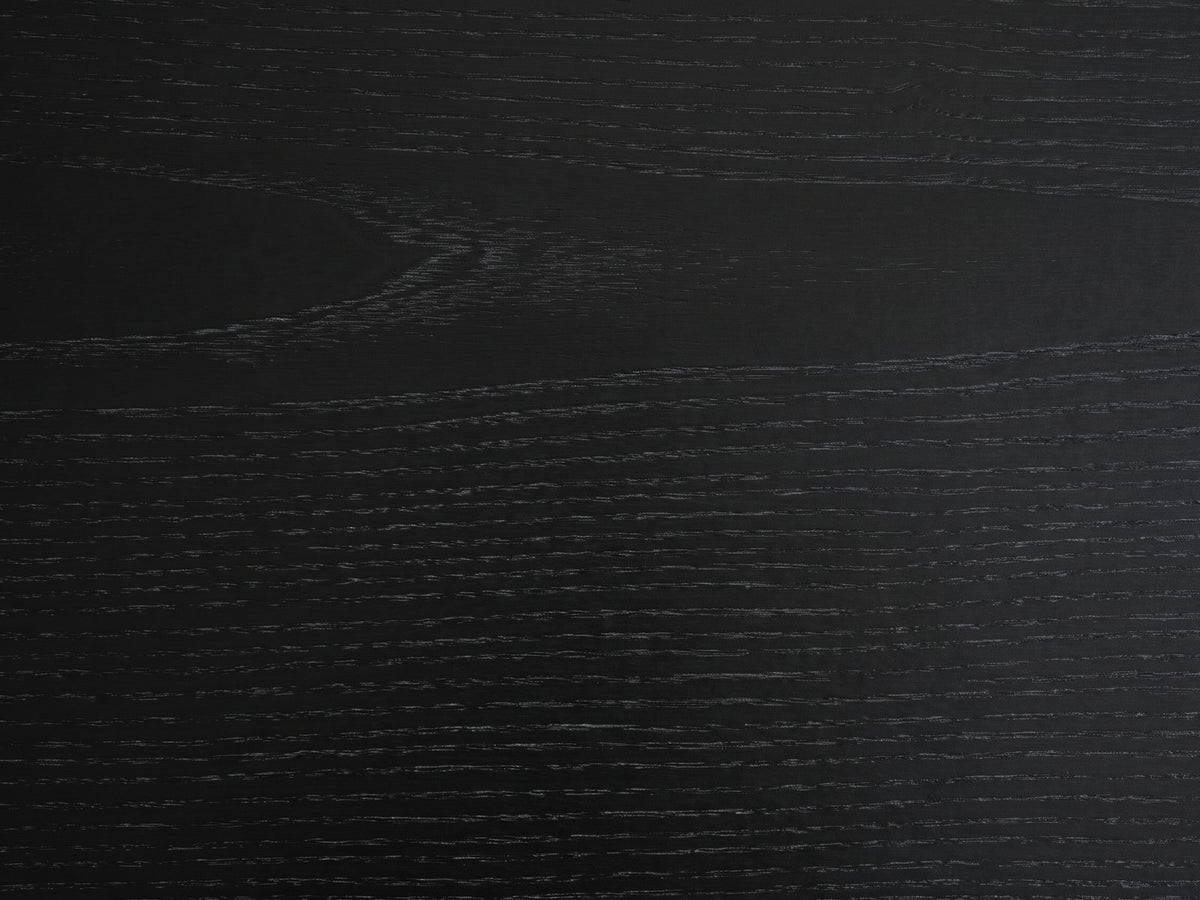 Close-up of the Atina Black Ash Oval Console Table: the open-pore black ash grain of the top