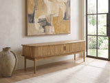 Atrani Reeded Curved Media Console seen from the side, under a large abstract painting in a bright living room