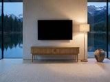 Atrani Reeded Curved Media Console under a wall-mounted screen in a mountain lake house at dusk