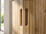 Close-up of the Atrani Reeded Curved Media Console: the reeded door front with two carved finger pulls