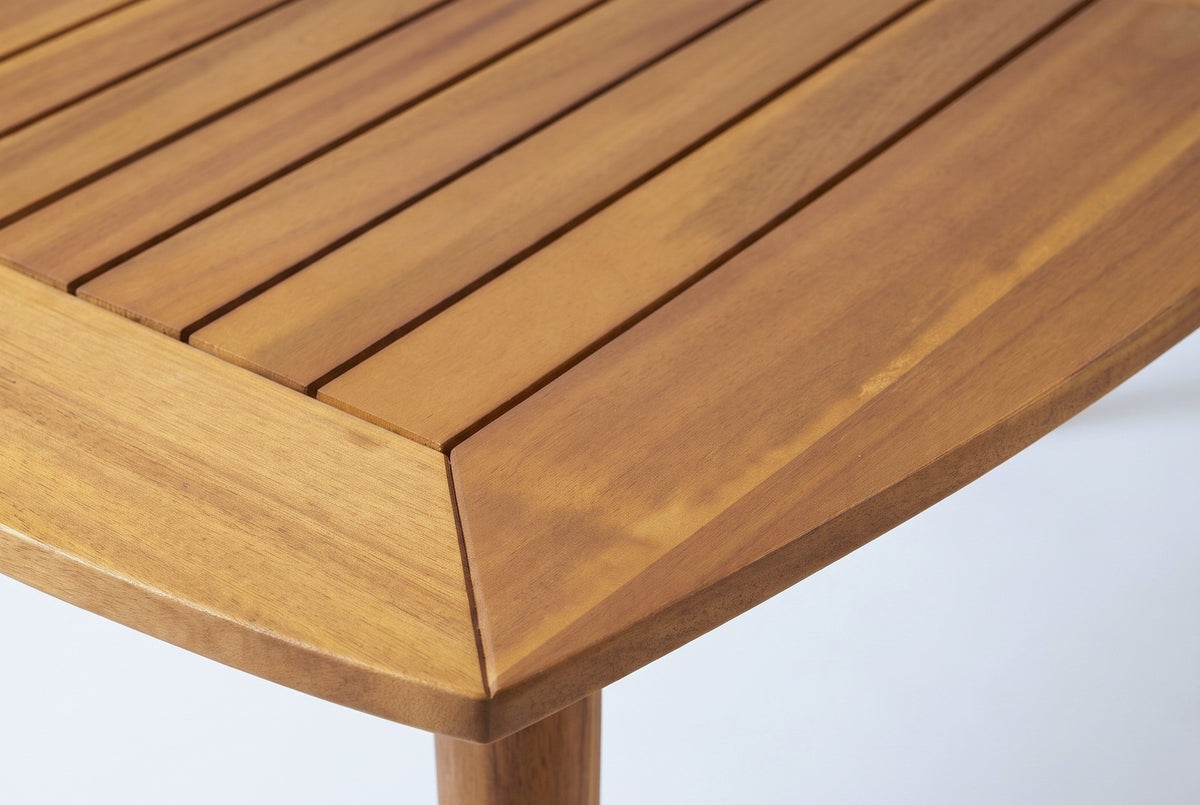 Close-up of an Augusta corner: the mitred acacia border, narrow slats with small gaps and the bevelled edge, a tapered leg below