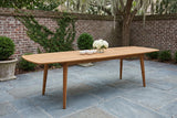 Augusta acacia dining table extended in a walled brick courtyard on bluestone flagstones, boxwood and a live oak with Spanish moss behind (chairs not included, bowls and flowers not included)