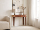 Avetrana Mango Wood and Cane Console Table against a plaster wall under an abstract canvas in a bright living room