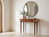 Avetrana Mango Wood and Cane Console Table under a round mirror in a travertine entryway