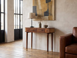 Avetrana Mango Wood and Cane Console Table against a plaster wall in an industrial loft