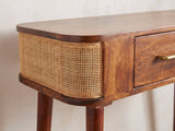 Close-up of the Avetrana Mango Wood and Cane Console Table: the cane-wrapped rounded end of the case beside a drawer with its brass-tone pull