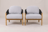 The two Avola club chairs seen from the front: square acacia front posts, gray seat cushions on rounded acacia seat frames and arched back cushions