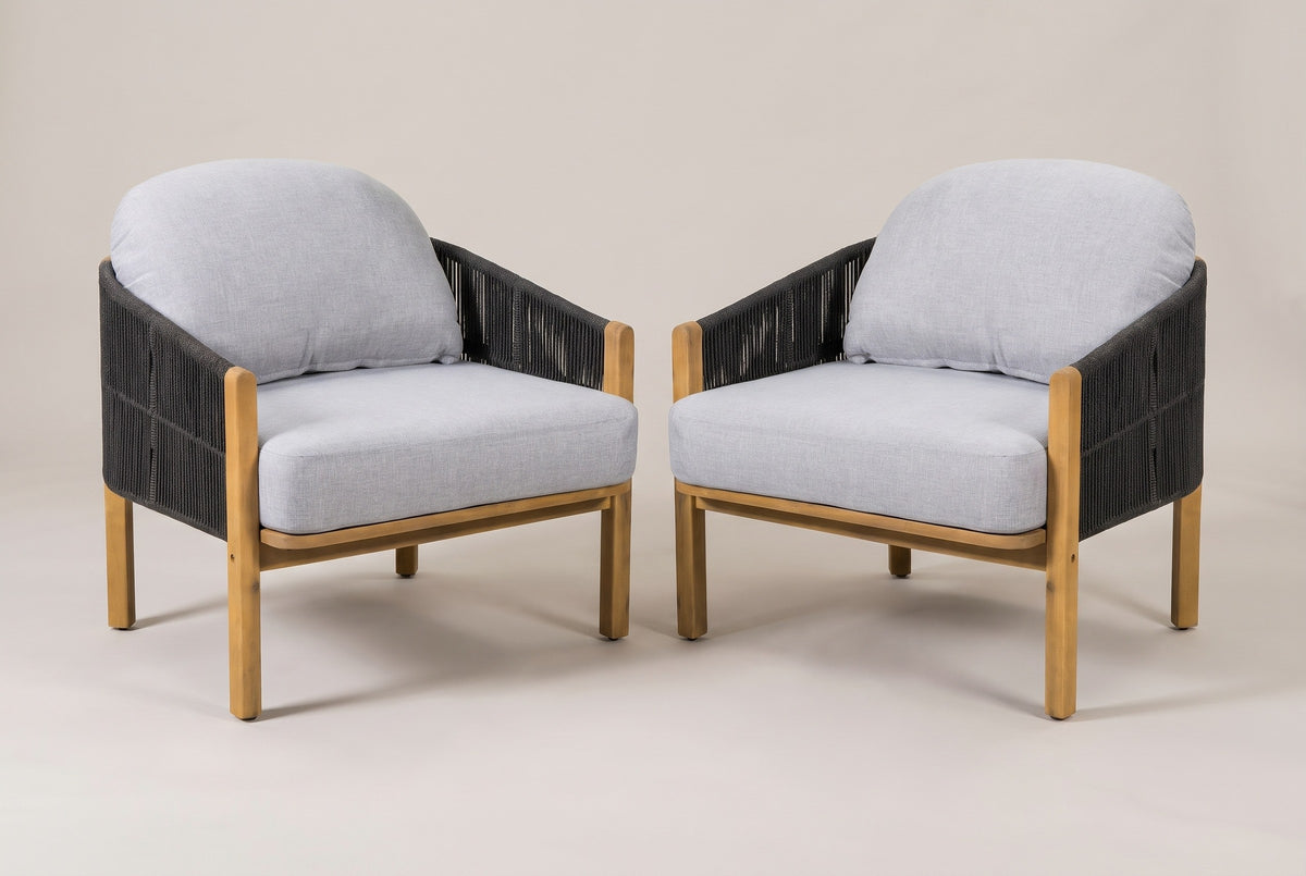The set of two Avola acacia and rope club chairs with gray cushions, three-quarter view on a light studio backdrop