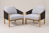 The set of two Avola acacia and rope club chairs with gray cushions, three-quarter view on a light studio backdrop
