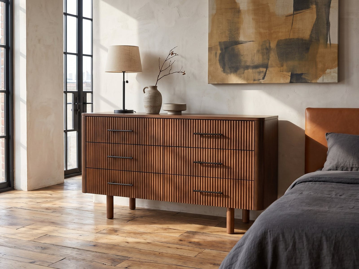 Badia 56-Inch Walnut-Finish 6-Drawer Dresser against a plaster wall in an industrial loft bedroom