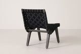 One Bagheria chair seen from behind: the woven back, the strap ends wrapped round the side rails, four splayed legs and the back stretcher