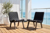 Two Bagheria lounge chairs on honey teak decking at an ocean-view house in Laguna Beach, a whitewashed board wall, a glass door and a glass rail with the Pacific behind (plant not included)
