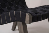 Close-up of a Bagheria seat corner: black rope straps wrapped round the grey-brown acacia side rail above a square leg