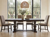 Bagnara 76.5 to 94.5-Inch Rustic Oak Double Pedestal Dining Set with 4 Chairs in a sunlit villa dining area with olive trees outside