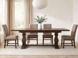 Bagnara 76.5 to 94.5-Inch Rustic Oak Double Pedestal Dining Set with 4 Chairs in a bright plaster dining room with linen curtains