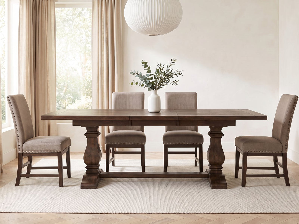Bagnara 76.5 to 94.5-Inch Rustic Oak Double Pedestal Dining Set with 4 Chairs in a bright plaster dining room with linen curtains