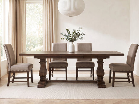 Bagnara 76.5 to 94.5-Inch Rustic Oak Double Pedestal Dining Set with 4 Chairs in a bright plaster dining room with linen curtains