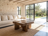 Barga Solid Sheesham Coffee Table on a jute rug in front of a linen sofa in a poolside villa