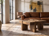 Barga Solid Sheesham Coffee Table on a vintage rug in front of a leather sofa in an industrial loft