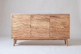 The Barile sideboard in light natural solid wood, front view on a light studio backdrop