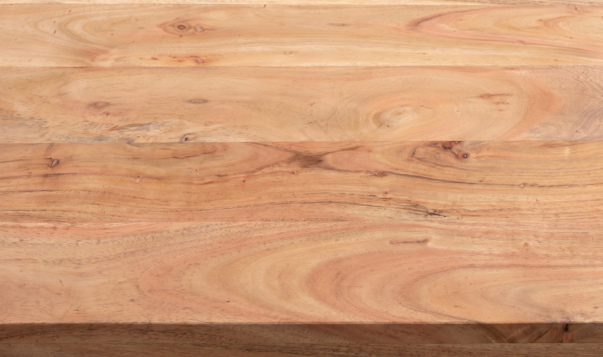 Close-up of the solid wood top of the Barile sideboard: light natural boards with pink and honey streaks, small pin knots and a square edge