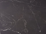 Close-up of the Barolo 35-Inch Round Black Sintered Stone Slatted Drum Coffee Table: the white veining of the matte black sintered stone top