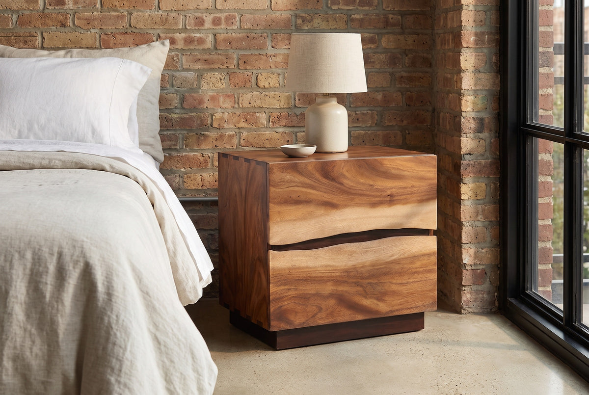Barumini suar nightstand against an exposed brick wall in a Chicago loft bedroom with a black steel window and a concrete floor