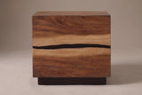 The Barumini nightstand in suar and walnut veneer, front view on a light studio backdrop