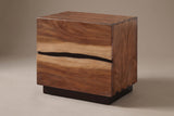 The Barumini two-drawer nightstand in suar and walnut veneer with a wavy gap between the drawers, three-quarter view on a light studio backdrop