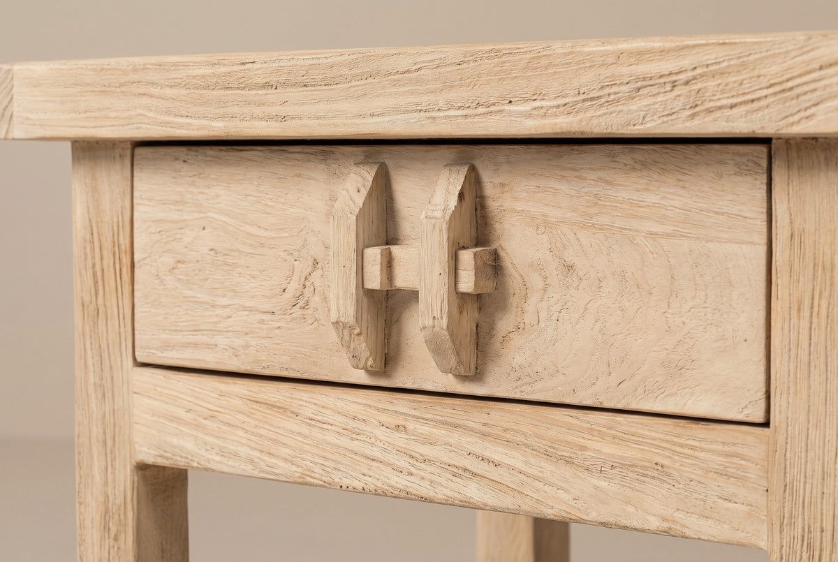 The drawer of the Baunei nightstand: the pull carved from elm, two upright blocks joined through the middle by a small peg, under the thick top