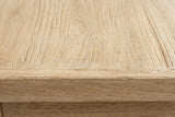 Close-up of the pale reclaimed elm on the Baunei nightstand: wavy grain with open pores running to a rounded edge