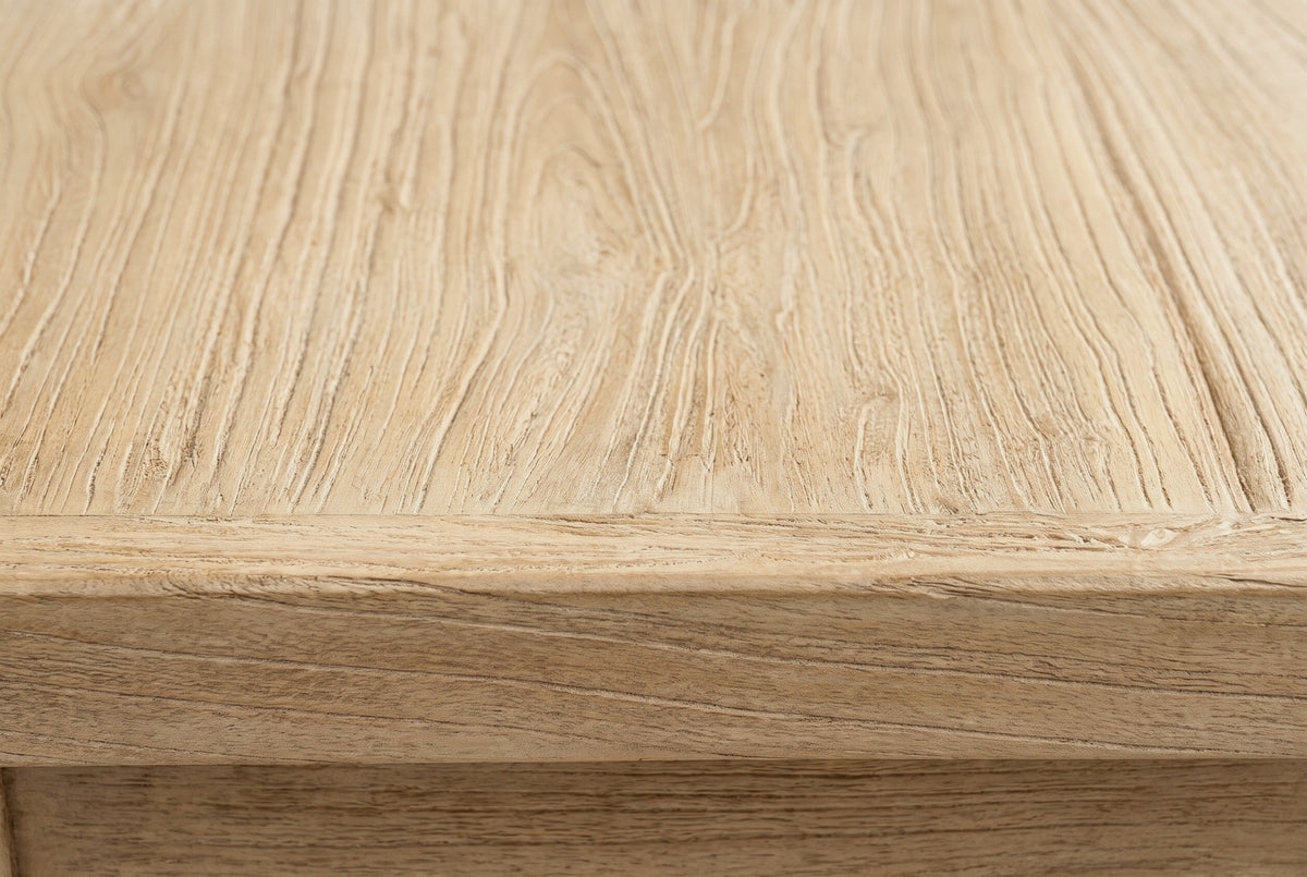 Close-up of the pale reclaimed elm on the Baunei nightstand: wavy grain with open pores running to a rounded edge